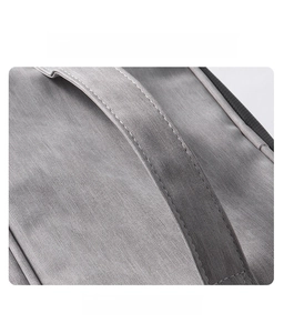 Detail of the durable grey fabric makeup bag showing reinforced handles and fine stitching