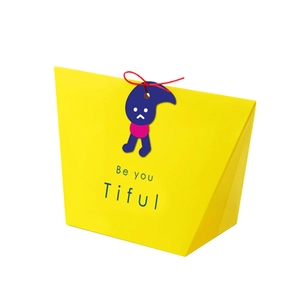Yellow trapezoid gift box with red drawstring and Be You Tiful text in 45-degree view