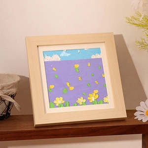Square wood frame with 3D impasto oil painting of flower field on a display shelf