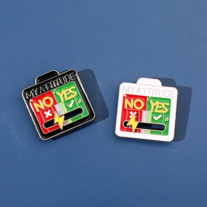 Sliding Yes or No mood enamel pins in black and white frames on a dark blue background