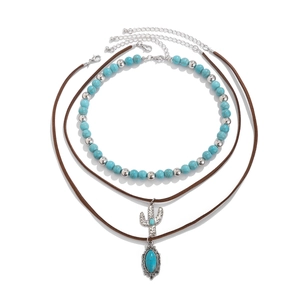 Detail of bohemian turquoise beaded choker and silver cactus pendant necklace set