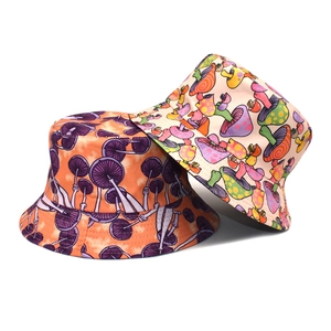 Reversible bucket hat with vibrant mushroom print in orange and beige canvas fabric