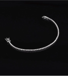 Close-up of 2mm moissanite tennis bracelet in S925 silver on black reflective surface