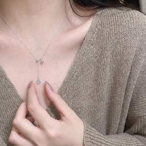 S925 Sterling silver necklace with blue water drop sapphire pendant on elegant female model