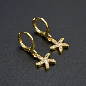 Sparkling gold starfish drop earrings with zircon crystals shown in a 45-degree angle