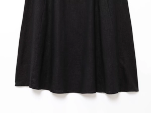 Detailed macro view of black linen blend dress hem showing high quality fabric texture