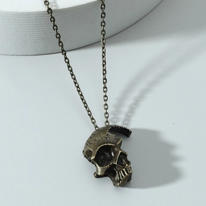 Retro bronze half skull necklace with gothic punk pendant on white circular stand