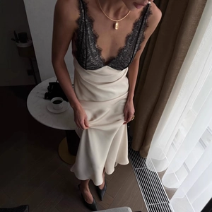 Elegant ivory satin slip dress with black lace trim and sexy backless design
