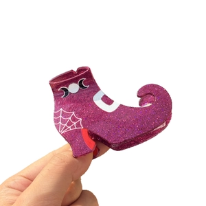 Pink glittery witch boot hair claw with moon and spider web patterns for Halloween