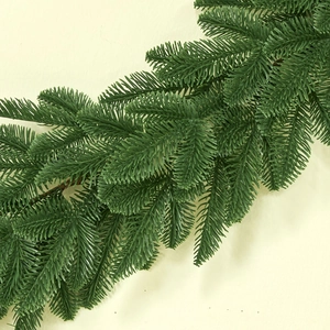 Realistic green faux pine garland for festive Christmas home decor on cream background