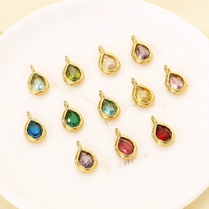 Macro shot of colorful teardrop gemstone charms in gold stainless steel settings