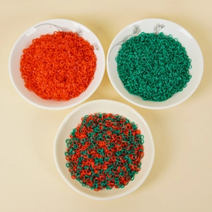 PVC artificial green onion and chili rings in floral ceramic bowls on beige surface