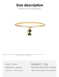 Detailed view of elastic pearl bracelet with black enamel bear charm and gold beads