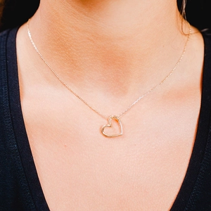 Elegant 925 sterling silver hollow heart pendant necklace in gold finish worn by model