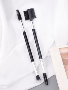 Dual-ended makeup brush set featuring a spiral spoolie, soft blending brush, and eyebrow comb