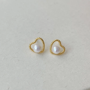 Close-up of heart-shaped gold twisted rope studs with white freshwater pearls