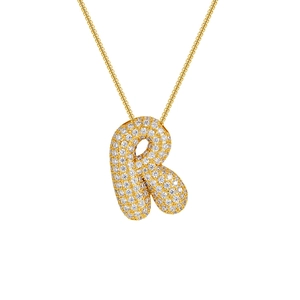 Macro detail of 18K gold plated letter R pendant with cubic zirconia micro-pave setting