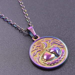 Macro shot of 18k gold-plated iridescent fox relief pendant on stainless steel chain