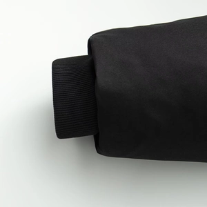 Detailed close-up of black windproof jacket sleeve showing elastic ribbed cuff texture
