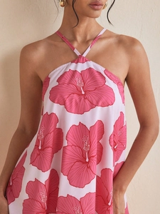 Pink and white halter neck dress featuring vibrant red hibiscus floral print pattern