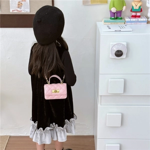 Pink quilted crossbody bag with gold chain for girls shown on a child model back view