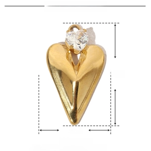 Macro detail of a vintage gold heart pendant with dimensions 18mm by 10mm and zircon