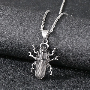 Detailed close-up of a vintage silver beetle pendant with intricate insect leg details