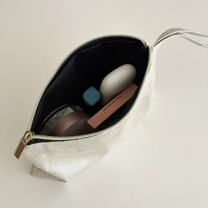 Interior view of silver glitter makeup bag showing storage capacity for cosmetics