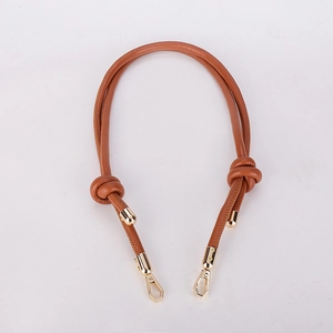 Detail view of brown leather bag strap with polished gold metal hooks for DIY handbags