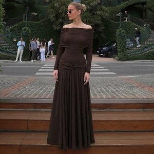 Detail of dark brown off-shoulder long-sleeved maxi dress with pleated texture in autumn style