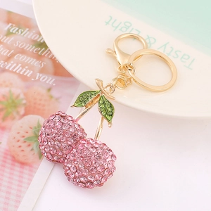 3D cherry keychain with pink rhinestones and green enamel leaf on golden metal ring