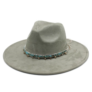 Detail of dark fedora hat with turquoise beads and leather cord ethnic band