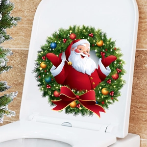 Detail of Christmas Santa and wreath wall sticker applied on a white toilet lid