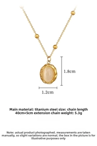 Detail view of gold titanium necklace with cat eye stone pendant and product dimensions