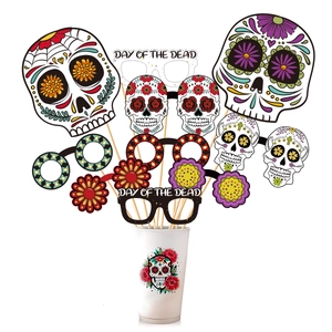 Day of the Dead photo booth props set with colorful skull and floral designs on sticks