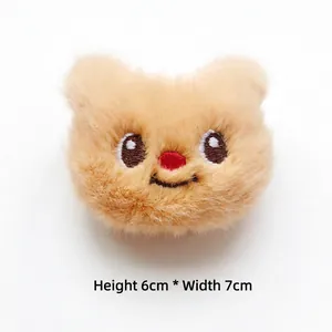 Close-up of cute 6x7cm plush bear head charm with embroidered details for DIY decor