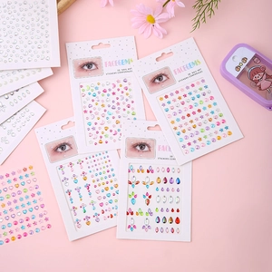 Detail view of 3D face gems and nail art stickers with stars, hearts and moon shapes