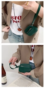 Green PU leather mini coin purse with wristlet strap shown in detailed lifestyle wear