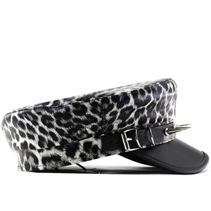 Close-up of leopard print punk cap with black leather brim and sharp silver metal rivets