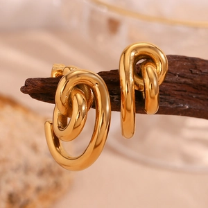 Detail of twisted chain link hoop earrings in 18K gold plated stainless steel finish