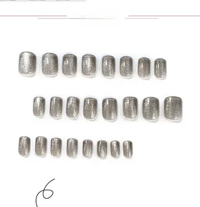 Detailed view of silver cat eye press-on nails in short square oval shape set of 24