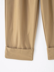 Close-up detail of khaki twill casual trousers showing the wide cuffed hem design