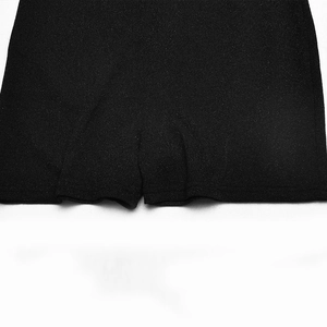 Close-up of black textured fabric showing high-quality stitching on jumpsuit shorts