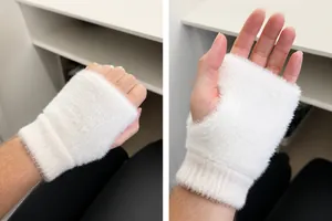 Close-up of white plush fingerless gloves featuring ribbed knit wrist warmers for winter