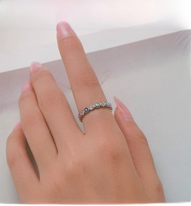 Detail of S925 silver ring featuring colorful enamel evil eyes and sparkling zircon pavé