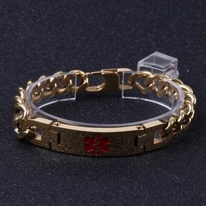 Detailed view of a gold Cuban link medical alert bracelet with a red Star of Life symbol