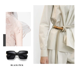 Detail view of stylish black square frame sunglasses in a fashion-forward magazine style