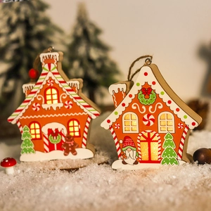 Close-up of LED glowing wooden gingerbread house hanging ornaments for Christmas tree