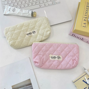 Detailed close-up of quilted macaron-colored stationery bags with heart-shaped zipper pulls