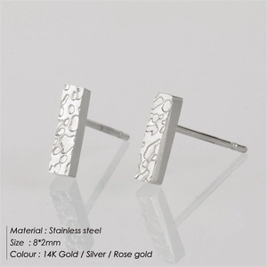 Macro detail of rectangular stainless steel stud earrings with hammered texture finish